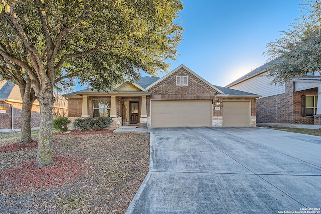 view of front of property featuring a garage, concrete driveway, and brick siding