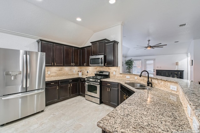 kitchen featuring visible vents, appliances with stainless steel finishes, light stone counters, and a sink