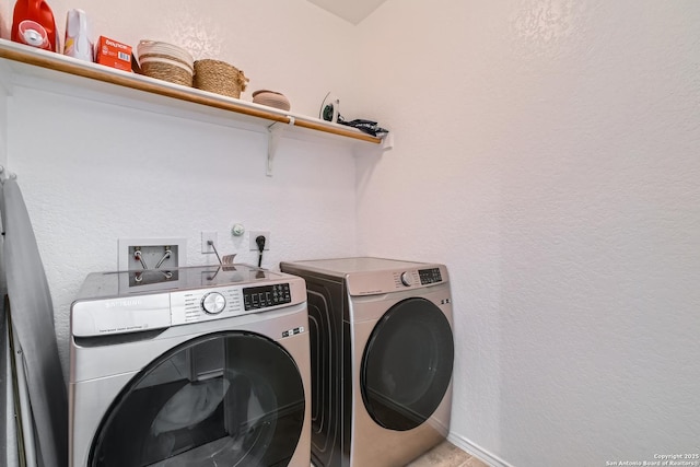 washroom with laundry area and washer and dryer