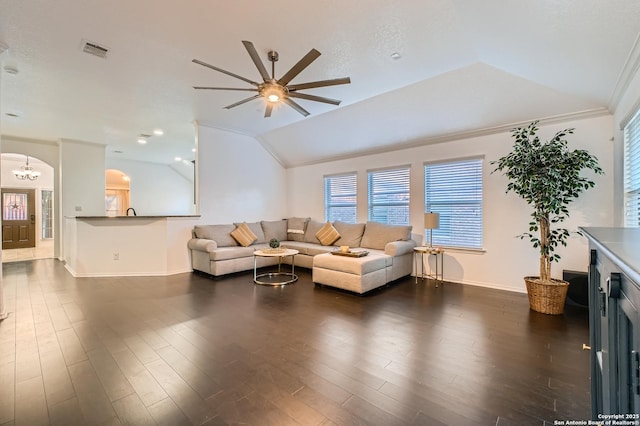 living area with arched walkways, lofted ceiling, visible vents, dark wood-type flooring, and ornamental molding