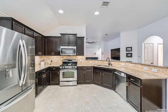 kitchen featuring light stone counters, a sink, visible vents, appliances with stainless steel finishes, and decorative backsplash