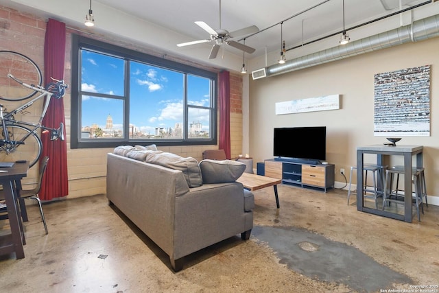 living area featuring a ceiling fan, visible vents, concrete floors, and baseboards