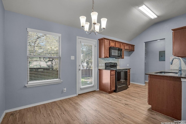 kitchen featuring dark countertops, brown cabinets, a sink, and black appliances