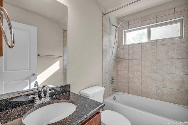 bathroom featuring toilet,  shower combination, and vanity