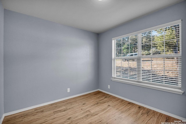 empty room featuring light wood-style floors and baseboards