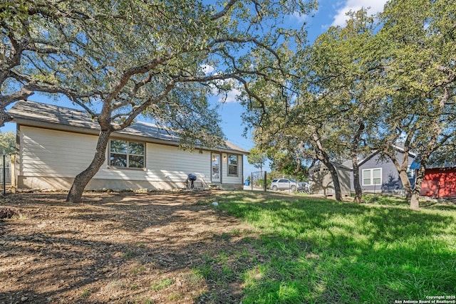 rear view of house with a yard