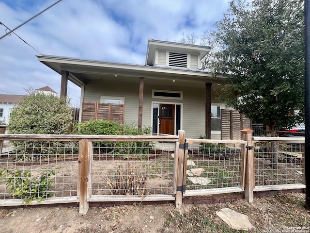 bungalow-style home featuring a fenced front yard and a gate