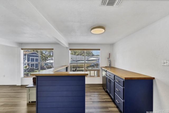 kitchen with dark wood-style floors, visible vents, blue cabinetry, wood counters, and dishwasher