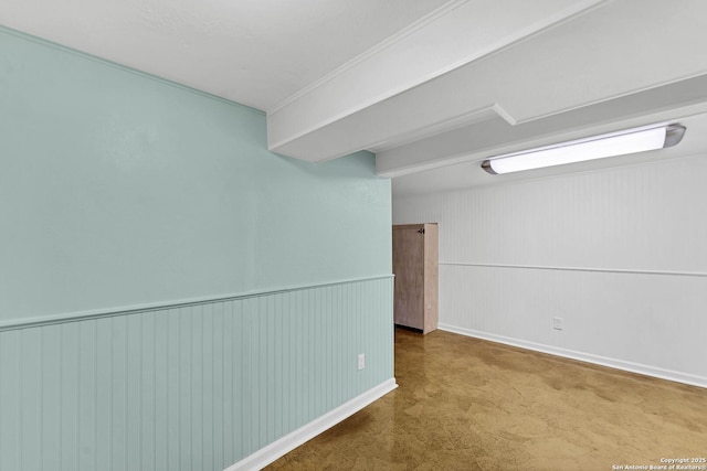 unfurnished room with wainscoting