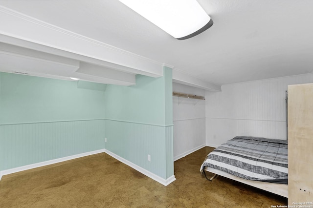 unfurnished bedroom with a wainscoted wall