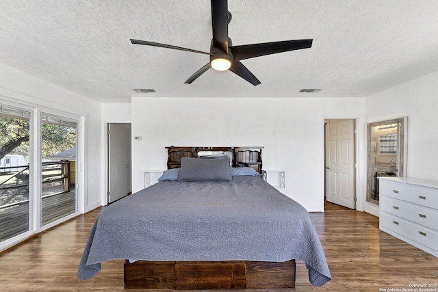 bedroom with access to exterior, visible vents, and wood finished floors