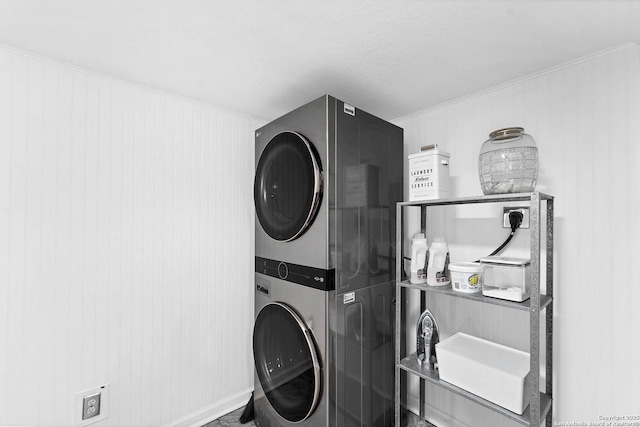 washroom featuring laundry area and stacked washing maching and dryer