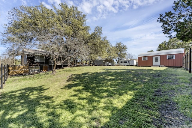 view of yard with an outdoor structure and fence