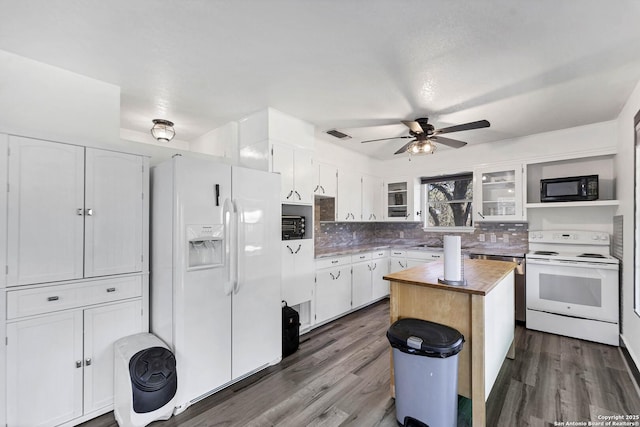 kitchen with white appliances, white cabinets, tasteful backsplash, and dark wood-style flooring