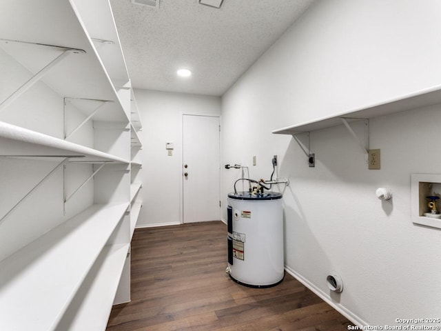 utility room with water heater and visible vents