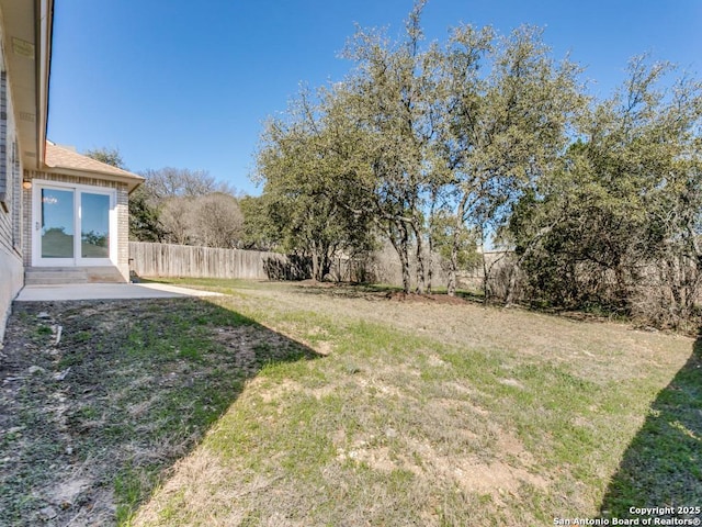 view of yard featuring a patio area and a fenced backyard