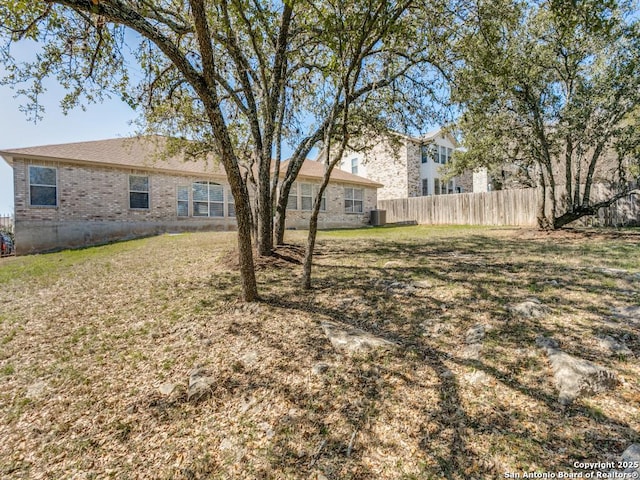 view of yard featuring cooling unit and fence