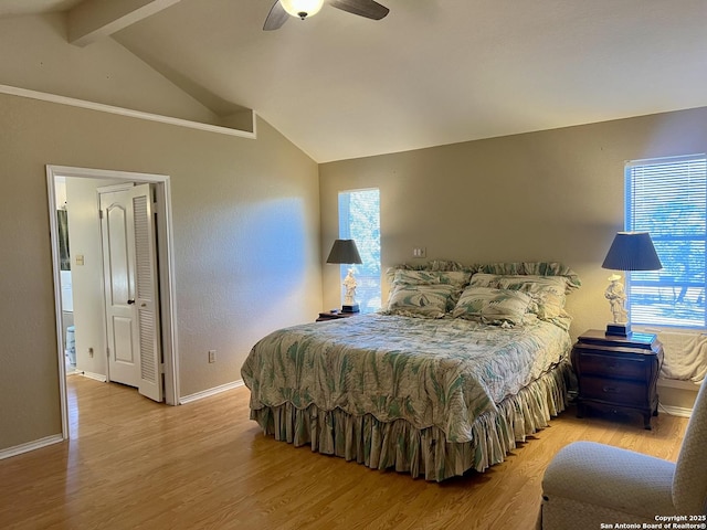 bedroom with light wood-type flooring, vaulted ceiling with beams, baseboards, and ceiling fan