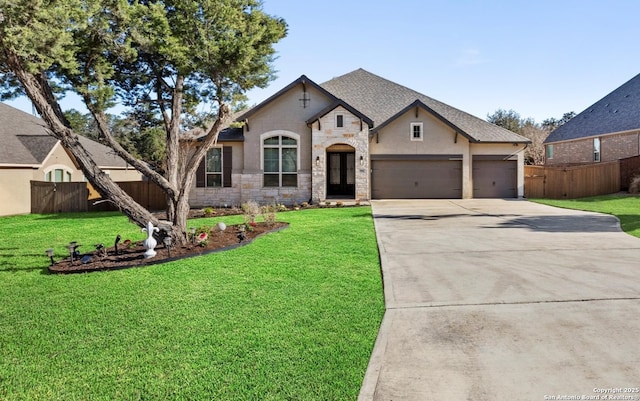 french provincial home featuring a garage, driveway, a front lawn, and fence