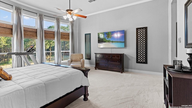 bedroom with light carpet, crown molding, visible vents, and baseboards