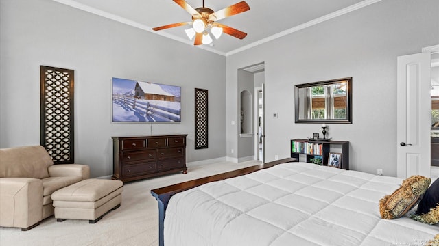 bedroom with baseboards, arched walkways, light colored carpet, ceiling fan, and ornamental molding