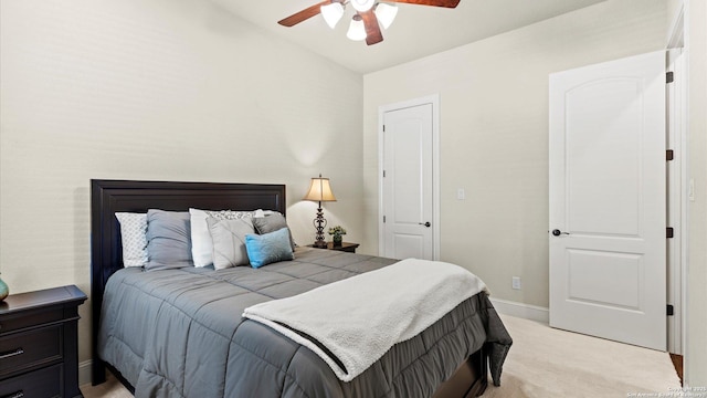 bedroom featuring baseboards, a ceiling fan, and light colored carpet