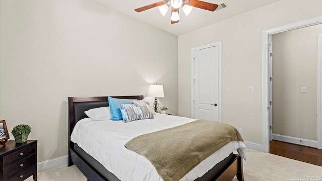 bedroom with visible vents, baseboards, and a ceiling fan