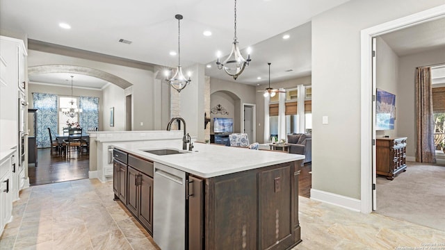 kitchen featuring light countertops, a sink, dishwasher, and dark brown cabinets