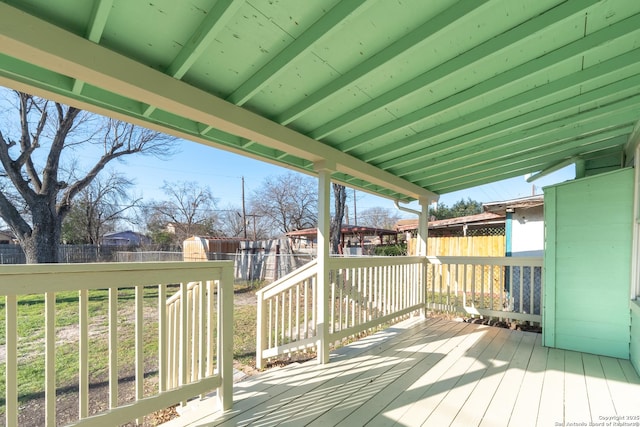 deck featuring a fenced backyard and an outdoor structure