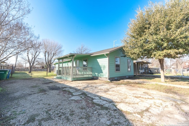 view of side of home featuring fence