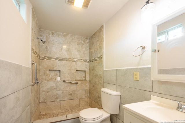 full bath featuring visible vents, a tile shower, tile walls, and toilet