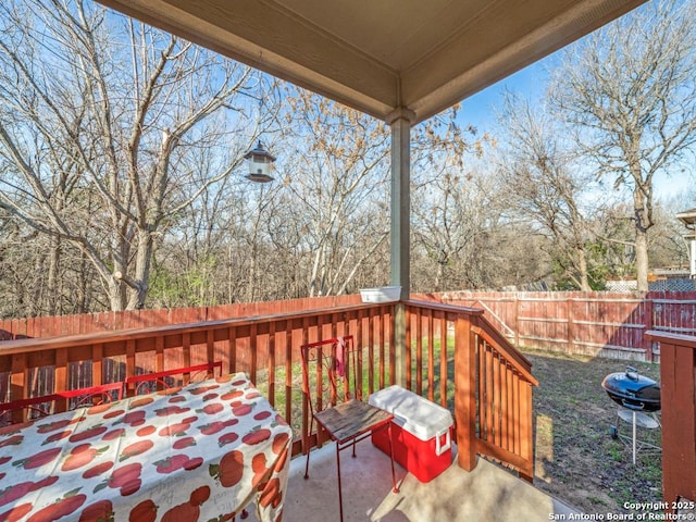 wooden deck featuring a fenced backyard and area for grilling