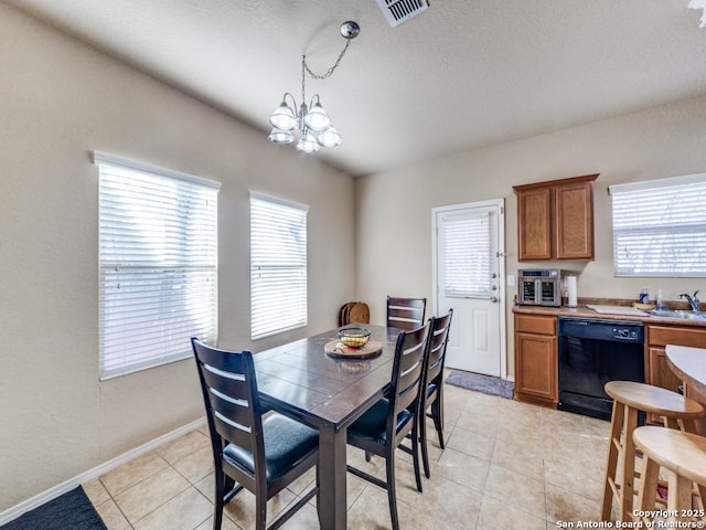 dining space featuring a wealth of natural light, visible vents, a notable chandelier, and light tile patterned floors