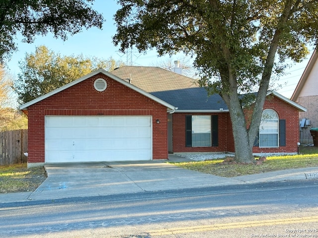 ranch-style house featuring an attached garage, brick siding, fence, driveway, and roof with shingles