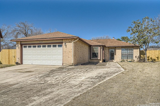 ranch-style house featuring a garage, driveway, fence, and brick siding