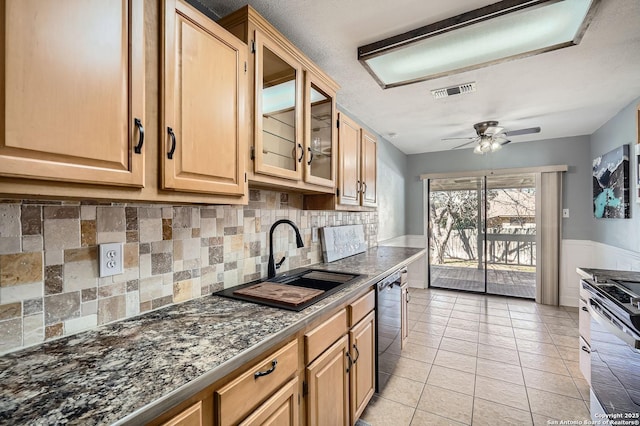 kitchen featuring light tile patterned flooring, a sink, a ceiling fan, electric stove, and dishwasher