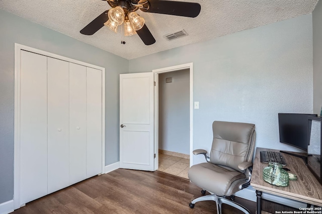 sitting room with visible vents, a ceiling fan, a textured ceiling, wood finished floors, and baseboards