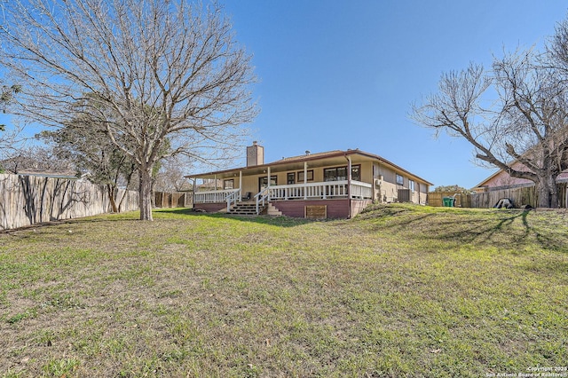 rear view of house featuring a porch, a lawn, a chimney, and fence