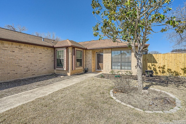 exterior space with brick siding and fence