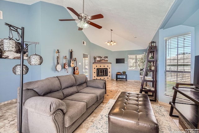 living room featuring high vaulted ceiling, light tile patterned floors, visible vents, and ceiling fan with notable chandelier