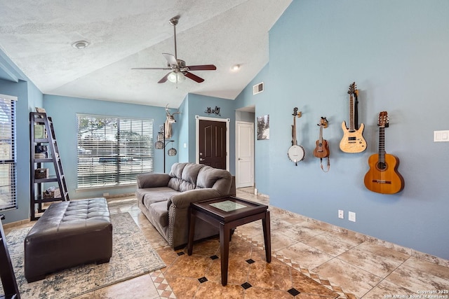 living area with vaulted ceiling, a textured ceiling, visible vents, and a ceiling fan