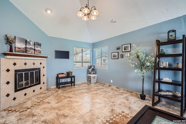 interior space with a chandelier, lofted ceiling, tile patterned floors, and a tile fireplace