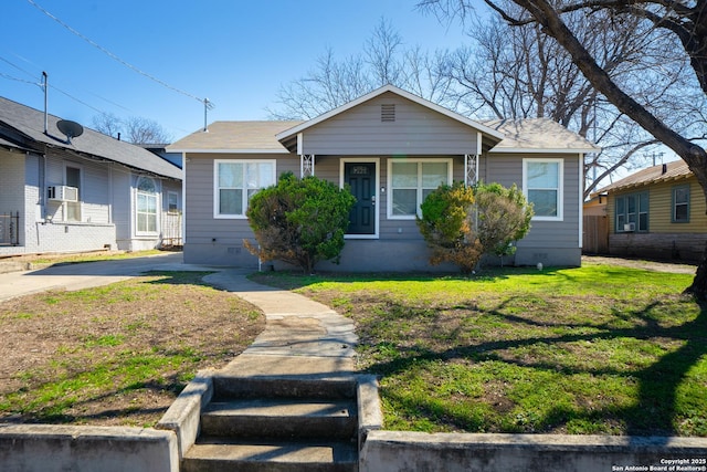 bungalow-style home featuring crawl space, a front yard, cooling unit, and fence