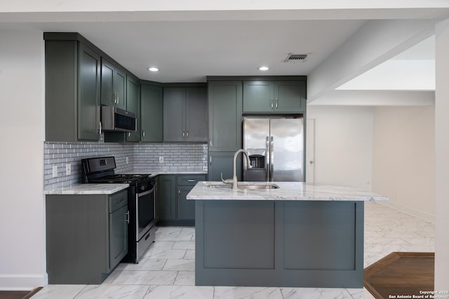 kitchen featuring marble finish floor, appliances with stainless steel finishes, light stone counters, and a sink