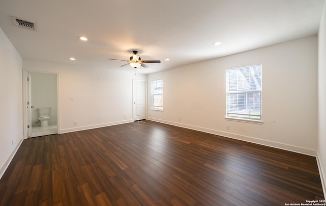 unfurnished room featuring dark wood-style floors, plenty of natural light, visible vents, and recessed lighting