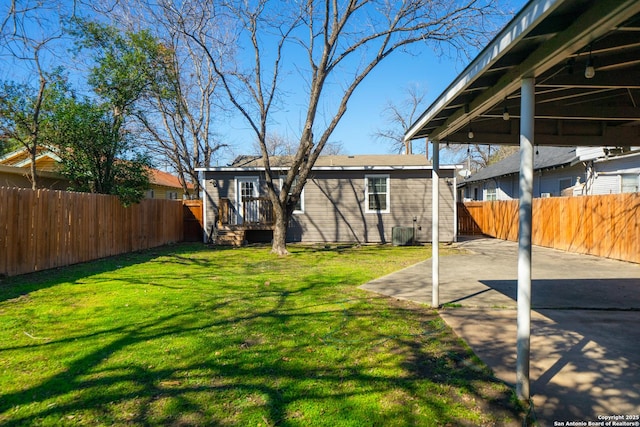 view of yard featuring ceiling fan, a patio area, and a fenced backyard