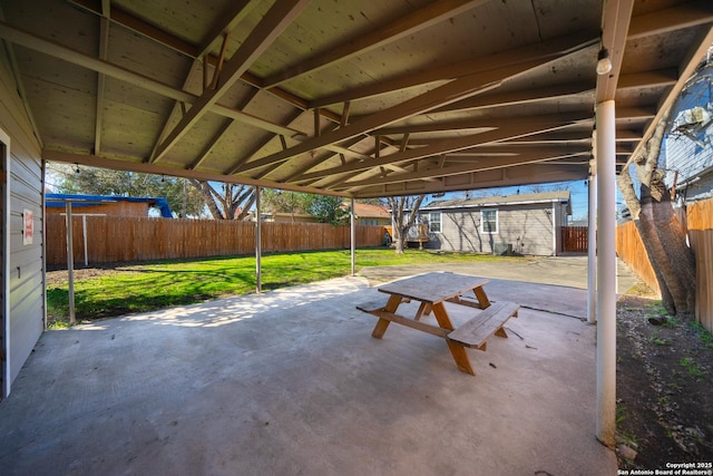 view of patio / terrace with a fenced backyard and an outdoor structure