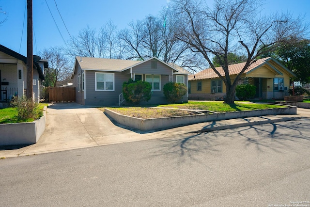 ranch-style house with crawl space, fence, driveway, and a front lawn