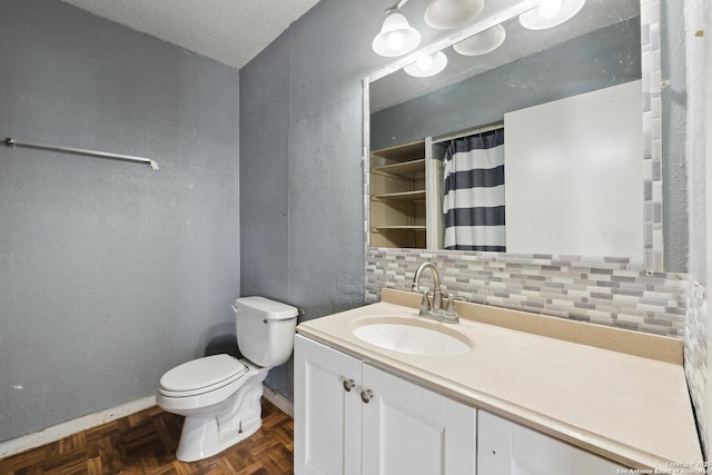 bathroom with a textured ceiling, a textured wall, toilet, vanity, and backsplash