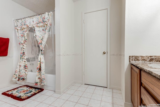 full bath with tile patterned flooring, shower / tub combo, vanity, and a textured ceiling